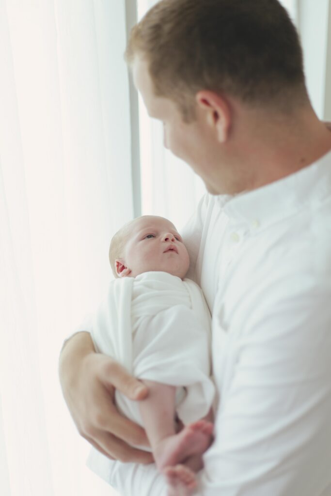 dad holding newborn baby