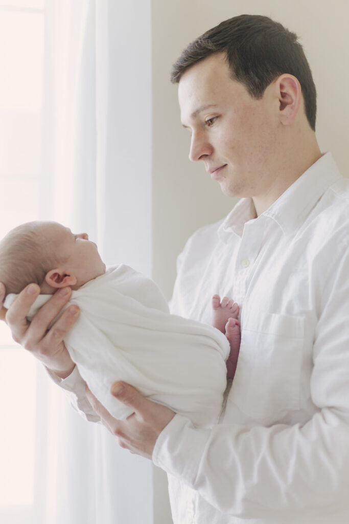 newborn baby posing with dad