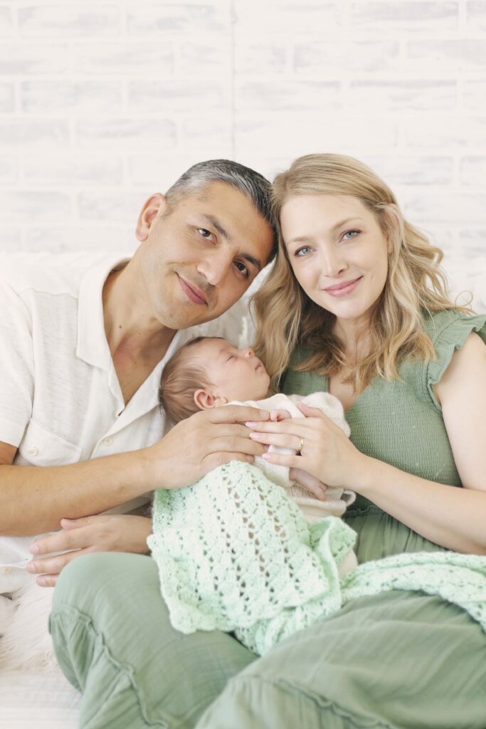 mom and dad holding newborn