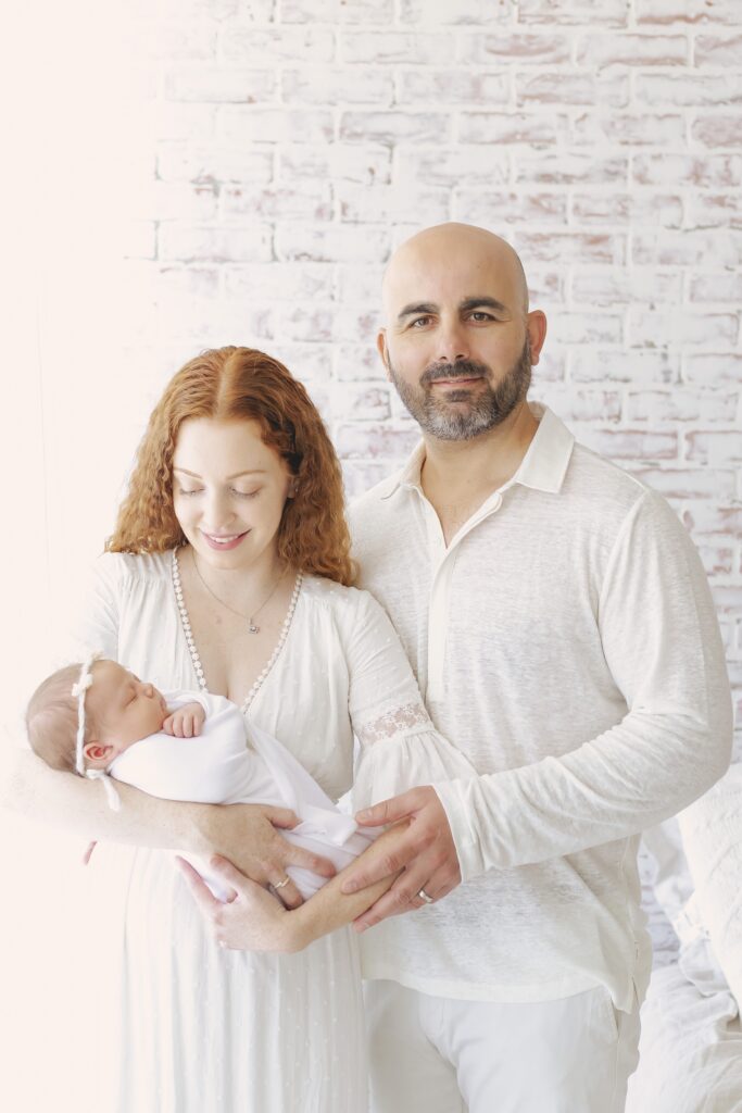 mom and dad holding newborn