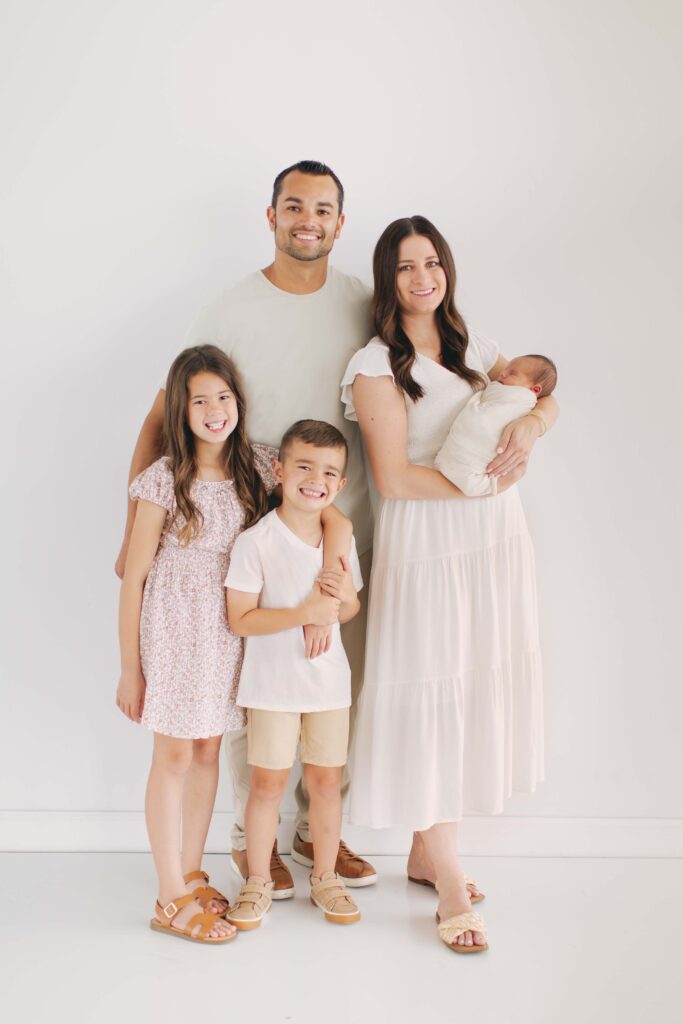 family posing together during their newborn photography session in omaha, nebraska